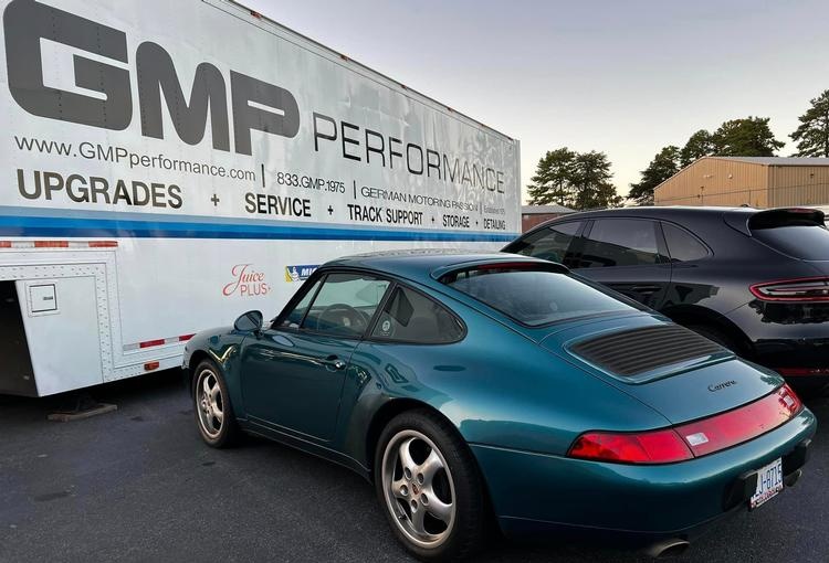 A classic Porsche 911 beside the GMP Performance trailer